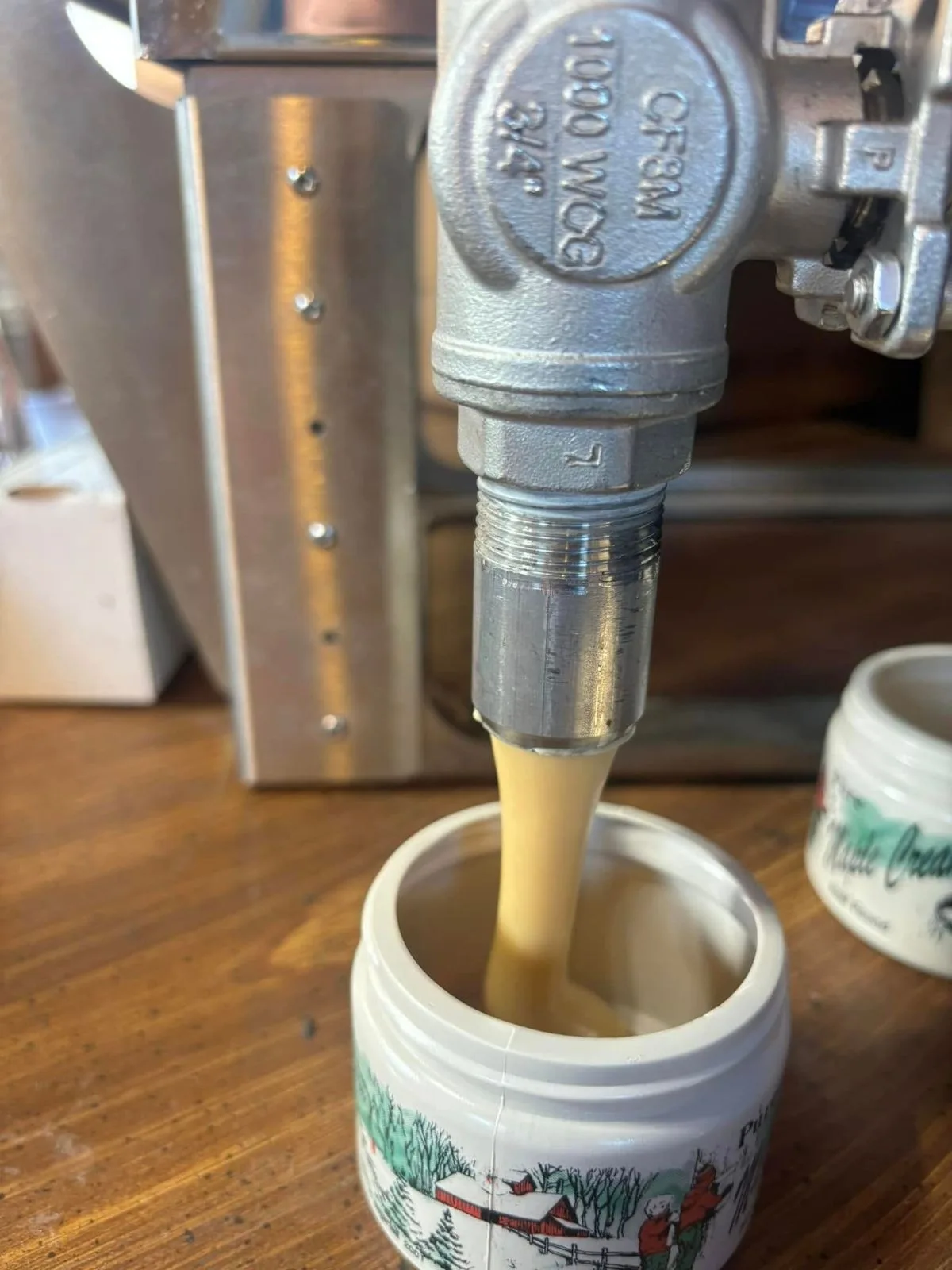 Maple cream filled from the valve into a jar